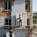 Isolation thermique par l'extérieur : pose de panneaux isolants sur façade de maison